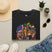 Black T-shirt with colorful Mardi Gras queen and American flag graphic on front