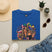 Royal blue T-shirt with Mardi Gras queen and American flag graphic on front