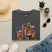 Dark gray T-shirt with Mardi Gras queen and American flag graphic on front