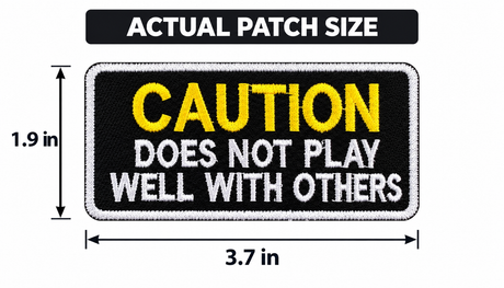Embroidered iron-on patch reading CAUTION: DOES NOT PLAY WELL WITH OTHERS